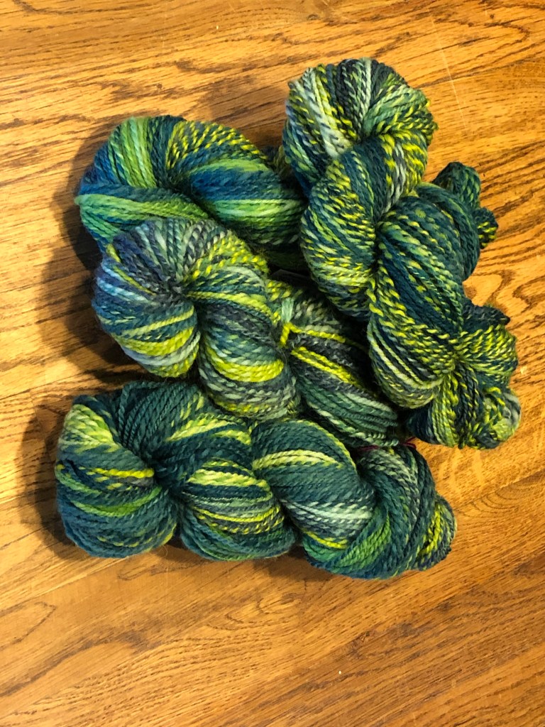 4 skeins of green variegated wool 2-ply yarn