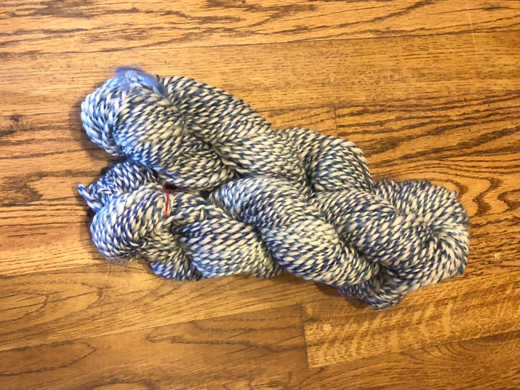 2 skeins of semi-worsted 2 ply white and blue candy cane striped wool yarn.