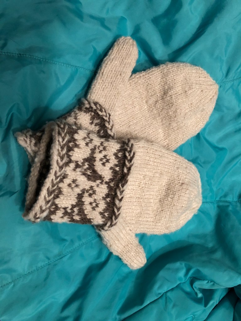 Brown and white hand knitted mittens from handspun Shetland wool.